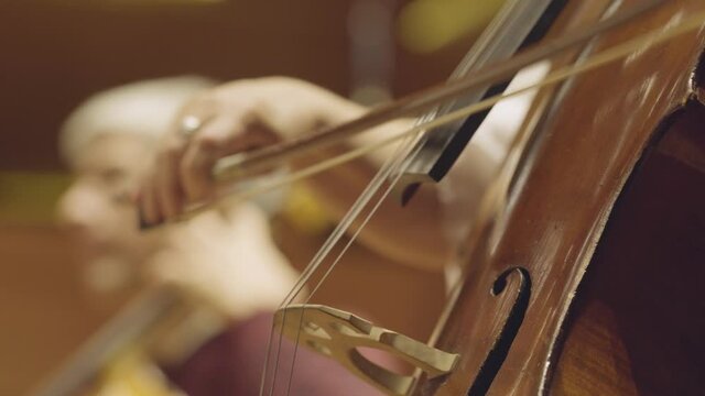 playing a cello, very close