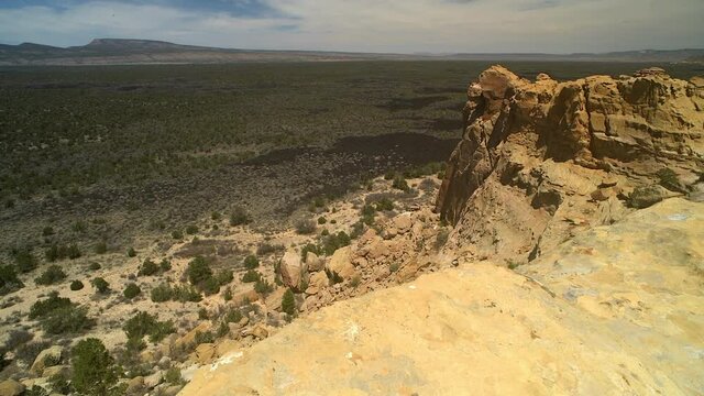 Sandstone Bluffs, El Malpais National Monument in the desert of New Mexico is a dramatic landscape made of Dakota Sandstone that contrasts with the dark lava flows below.