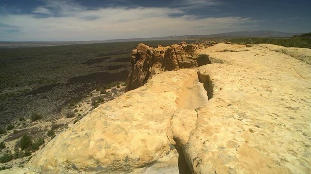 The Sandstone Bluffs, El Malpais National Monument in the desert of New Mexico is a dramatic landscape made of Dakota Sandstone that contrasts with the dark lava flows below. North America.