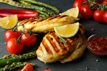 Concept of delicious food with grilled chicken meat on dark wooden background