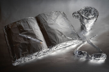 Iron home details. A book on the table wrapped with aluminum foil