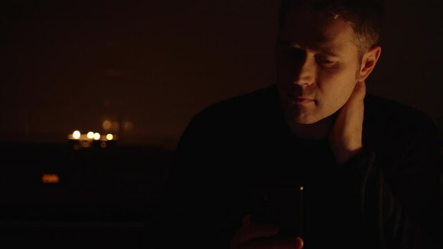 Handsome man using his smartphone at night.