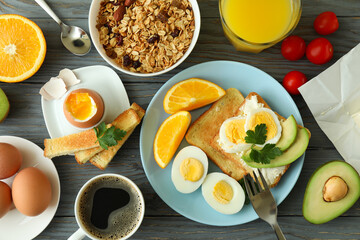 Concept of tasty breakfast on wooden background, top view
