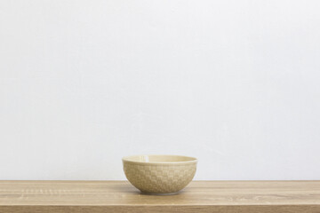 A white bowl on table over the light background.  