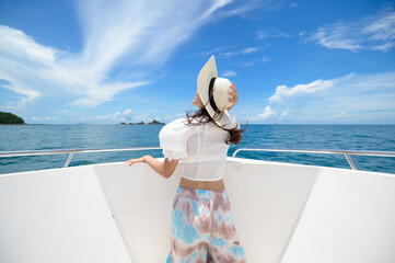 excited tourist enjoying and relaxing on speedboat with a beautiful view of ocean and mountain in...