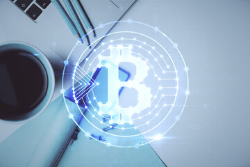 Blockchain theme hologram drawings over computer on the desktop background. Top view. Multi...