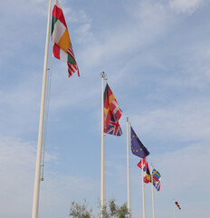 international flags blowing in the wind at the entrance to the campsite in the summer