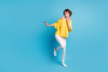 Full body photo of charming happy positive girl dance look empty space wear coll glasses isolated on blue color background