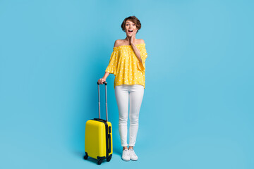 Full body photo of amazed happy girl hold hand cheek bag wear white pants vacation isolated on blue...