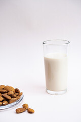 Almond milk with almond on the light background with copy space. Dairy free and lactose free nut milk, healthy eating, vegan and diet concept.
