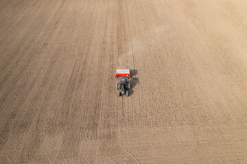 Tractor sowing a field in finland in spring.