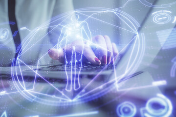 Double exposure of woman hands typing on computer and general theme hologram drawing. Education concept.
