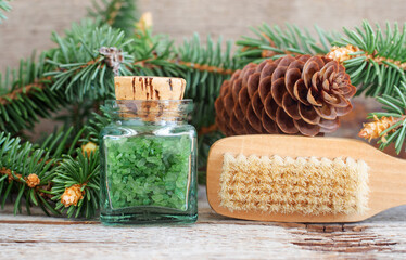 Small bottle with green aroma bath salts (foot soak) with coniferous extract and wooden massage...