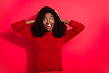 Photo of excited funny dark skin woman dressed casual pullover arms head looking empty space...