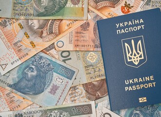 Ukrainian passport and polish zloty flat lay. Concept of working migration. Ukrainian immigration to Poland for better living