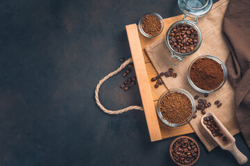 Different types of coffee: grain, granulated, ground on a brown background with space for copying.