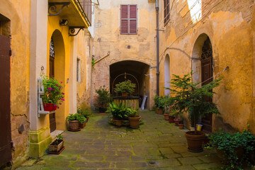Fototapeta na wymiar A residential courtyard in the historic medieval village of Buonconvento, Siena Province, Tuscany, Italy 