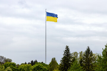 Ukraine national flag against a blue sky. Banner for inserting text about the freedom and independence of European country.