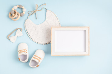 Fototapeta Mockup of empty frame with white baby accessories, baby shower, baptism invitation obraz