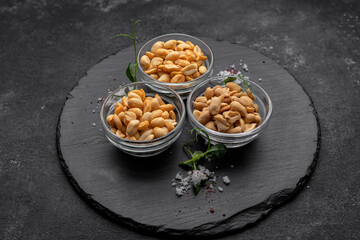 Roasted peanuts for beer, on a dark background