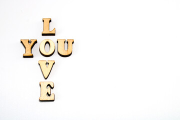 Wooden letters text arranged in cross shape: love you