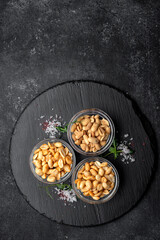 Roasted peanuts for beer, on a dark background
