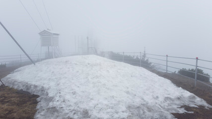 weather station and big pile of snow melting. fog landscape, Romania