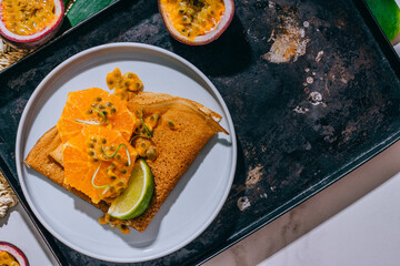 Crepes Or Thin Pancakes With Delicious passion fruit and lime.