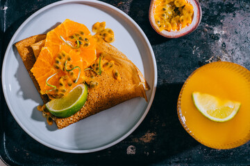 Crepes Or Thin Pancakes With Delicious passion fruit and lime.