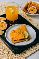Crepes Or Thin Pancakes With Delicious passion fruit and lime.
