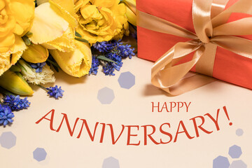 Card with the inscription Happy Anniversary on a background of yellow flowers and red gift