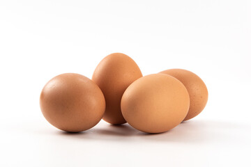 Raw brown chicken eggs on white background