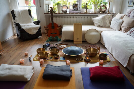 Sound healing set up with yoga mats and many instruments like RAV drum, monochord, guitar, tibetan singing bowls, cymbals, monochord, sansula.