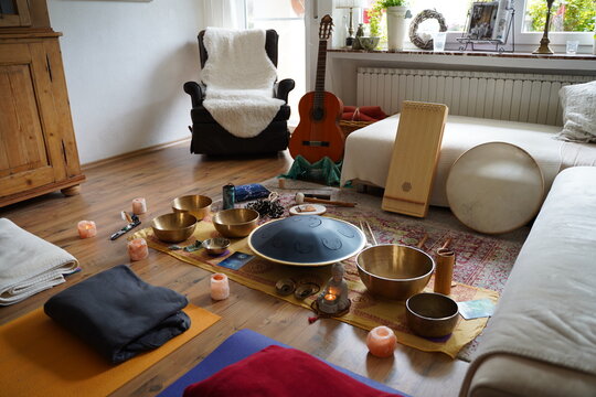 Sound healing set up with yoga mats and many instruments like RAV drum, monochord, guitar, tibetan singing bowls, cymbals, monochord, sansula.