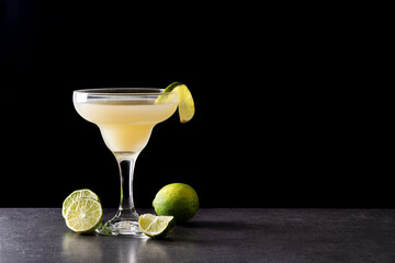 Classic daiquiri cocktail in glass on black background. Copy space
