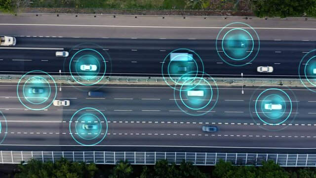 Aerial view of autonomous self driving cars driving on a highway. Autopilot concept.