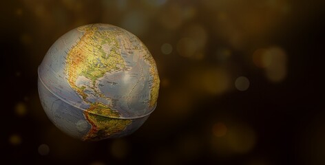 Obraz na płótnie Canvas Globe planet earth on a black background in space. Golden bokeh