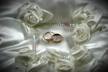 Wedding rings on a white pillow. Vignetting effect