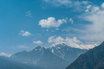 Clouds above the snow covered peak of the Himalayan mountain range at Manali in Himachal Pradesh, India