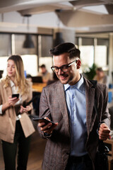Businessman in office. Portrait of smiling businessman using the phone.