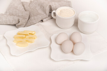 Flat lay food. Eggs, butter and flour. Dough ingredients.
