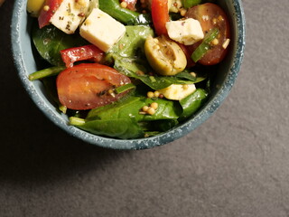 Fresh salad with cheese and olives close up