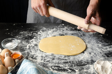 Chef's hands prepare dough for pizza. Fresh natural healthy food