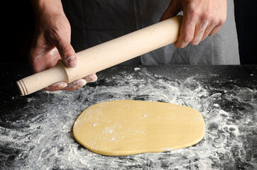 Chef's hands prepare dough for pizza. Fresh natural healthy food