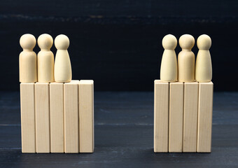 groups of wooden figures of men stand opposite each other. Conflict of interest concept, dialogue...