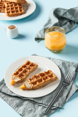 Oatmeal Belgian waffles in pencil shape on blue table
