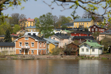 Fototapeta na wymiar Nice view of the old town of Porvoo, Finland. Scandinavian wooden houses on the river bank