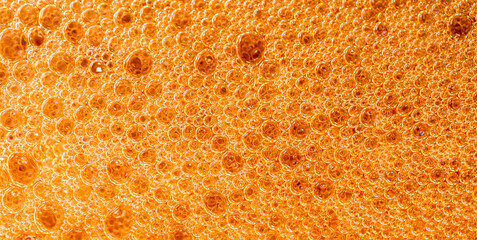 beer foam texture close up , porous ale bubble background macro , colored bar lager backdrop