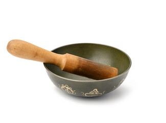 copper singing bowl and wooden clapper on a white background. Musical instrument for meditation, relaxation, various medical practices related to biorhythms