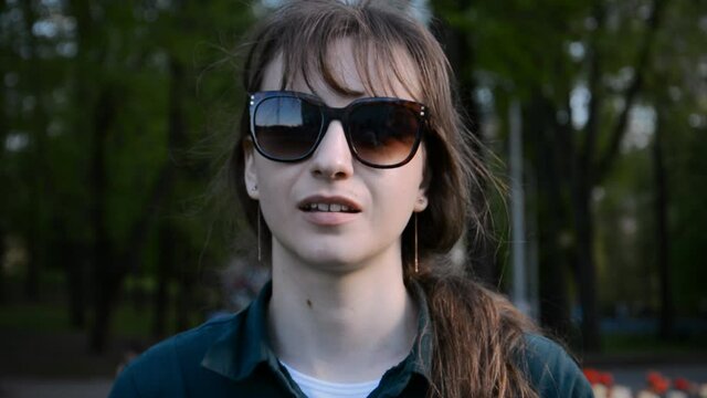 young beautiful girl in sunglasses evening portrait